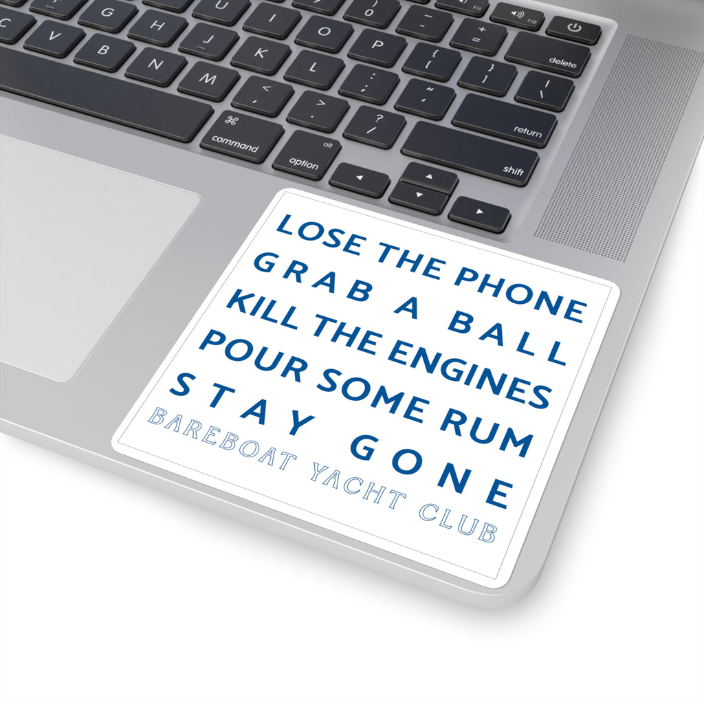 White motto sticker on a laptop: Lose the phone. Grab a ball. Kill the engines. Pour some rum. Stay gone.