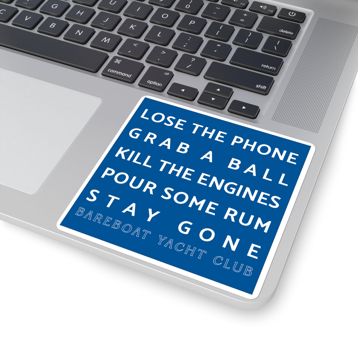 Blue motto sticker on a laptop: Lose the phone. Grab a ball. Kill the engines. Pour some rum. Stay gone.